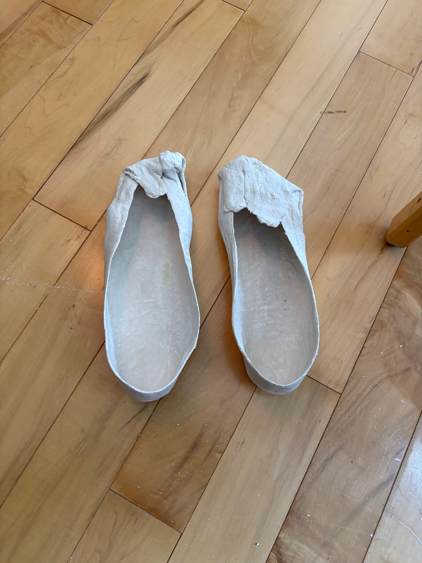 A pair of plaster foot casts, ready to become custom orthotics