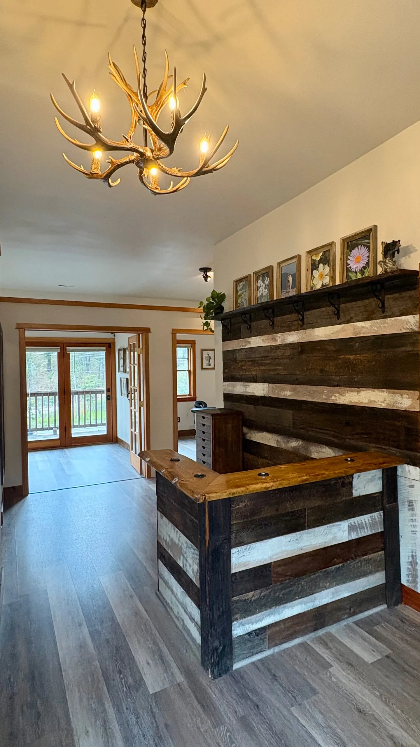 The Blue Mountain front desk in reclaimed barnwood under an antler chandelier