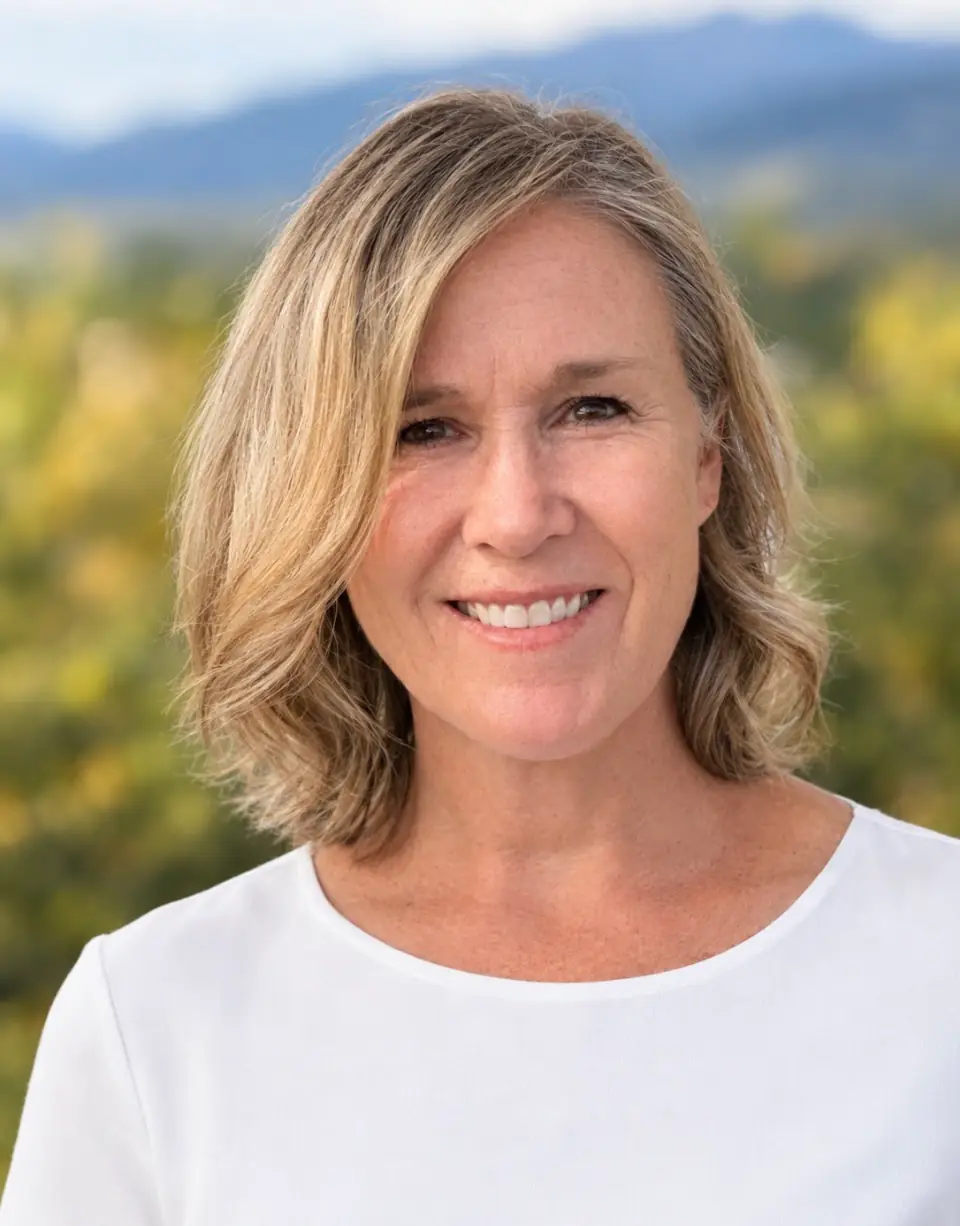 Dr. Tami Ellis outdoors with the mountains behind her